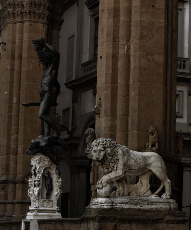 Image for photography page. A row of renaissance era lion statues carved from stone rest on pillars.