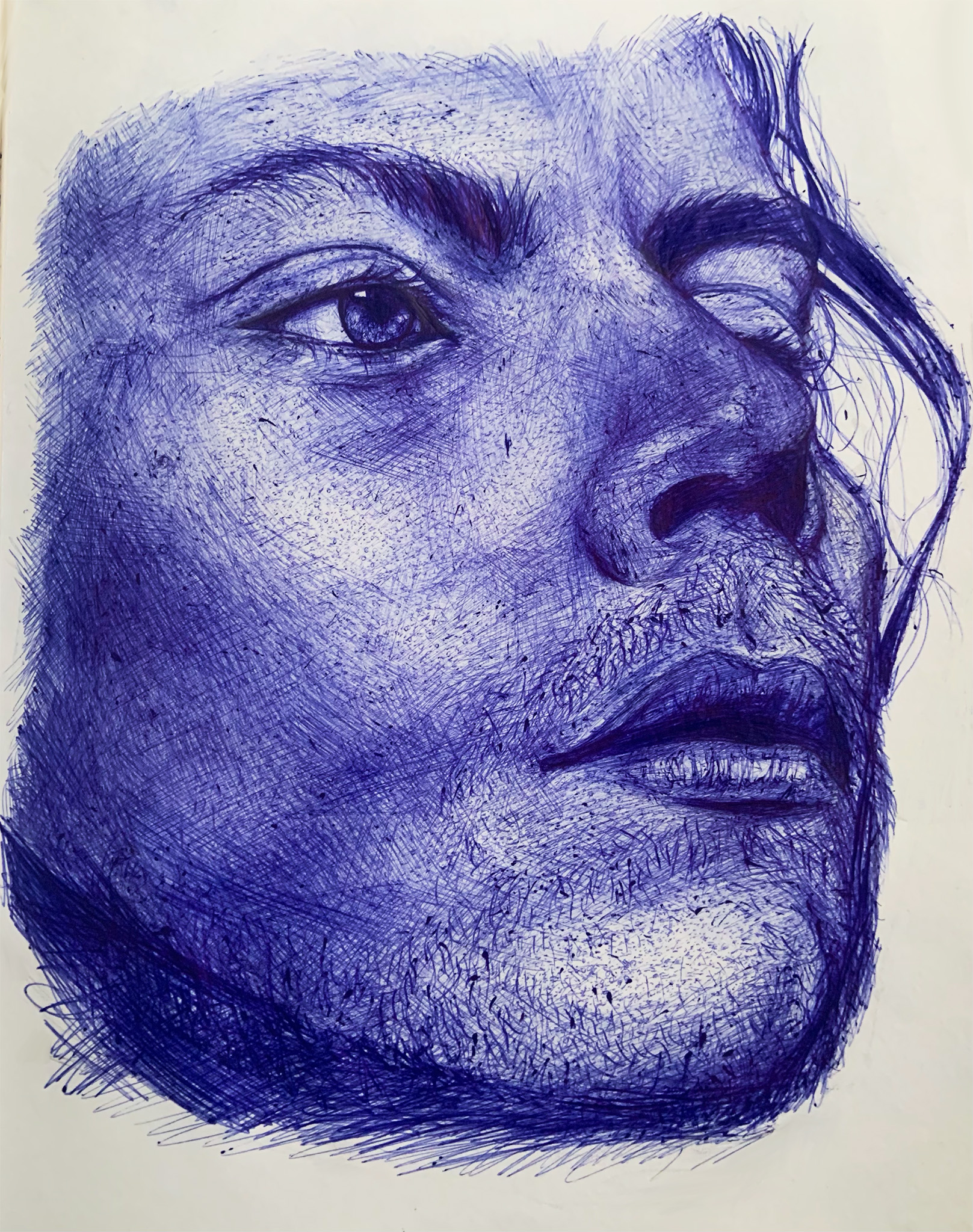Realistic portrait of a man's face done in blue pen ink.