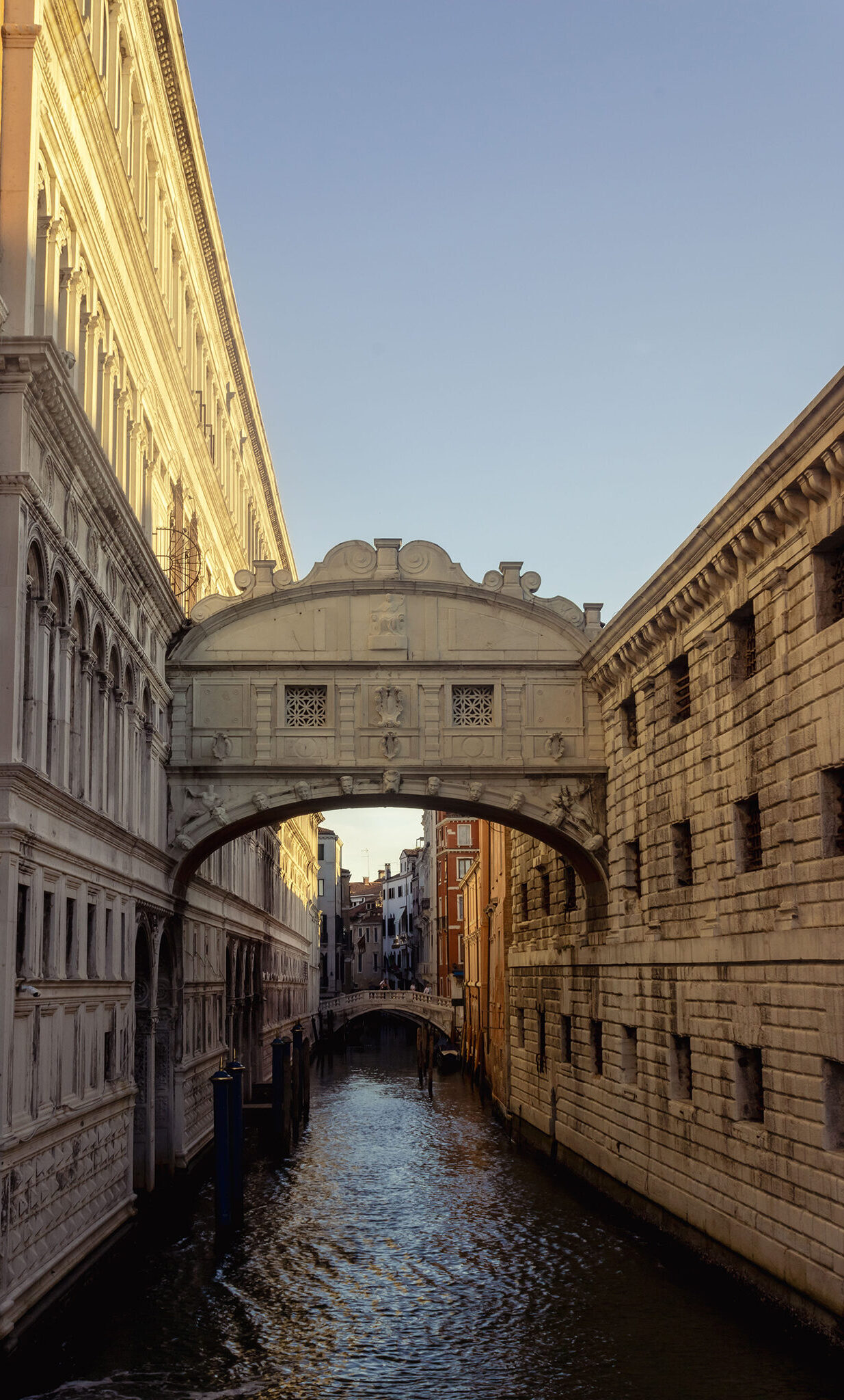 Depicts the bridge of sighs in Venice, Italy. The light of the rising sun casts interesting shadows across the bridge while the light brings out the vibrancy of the colours surrounding it.